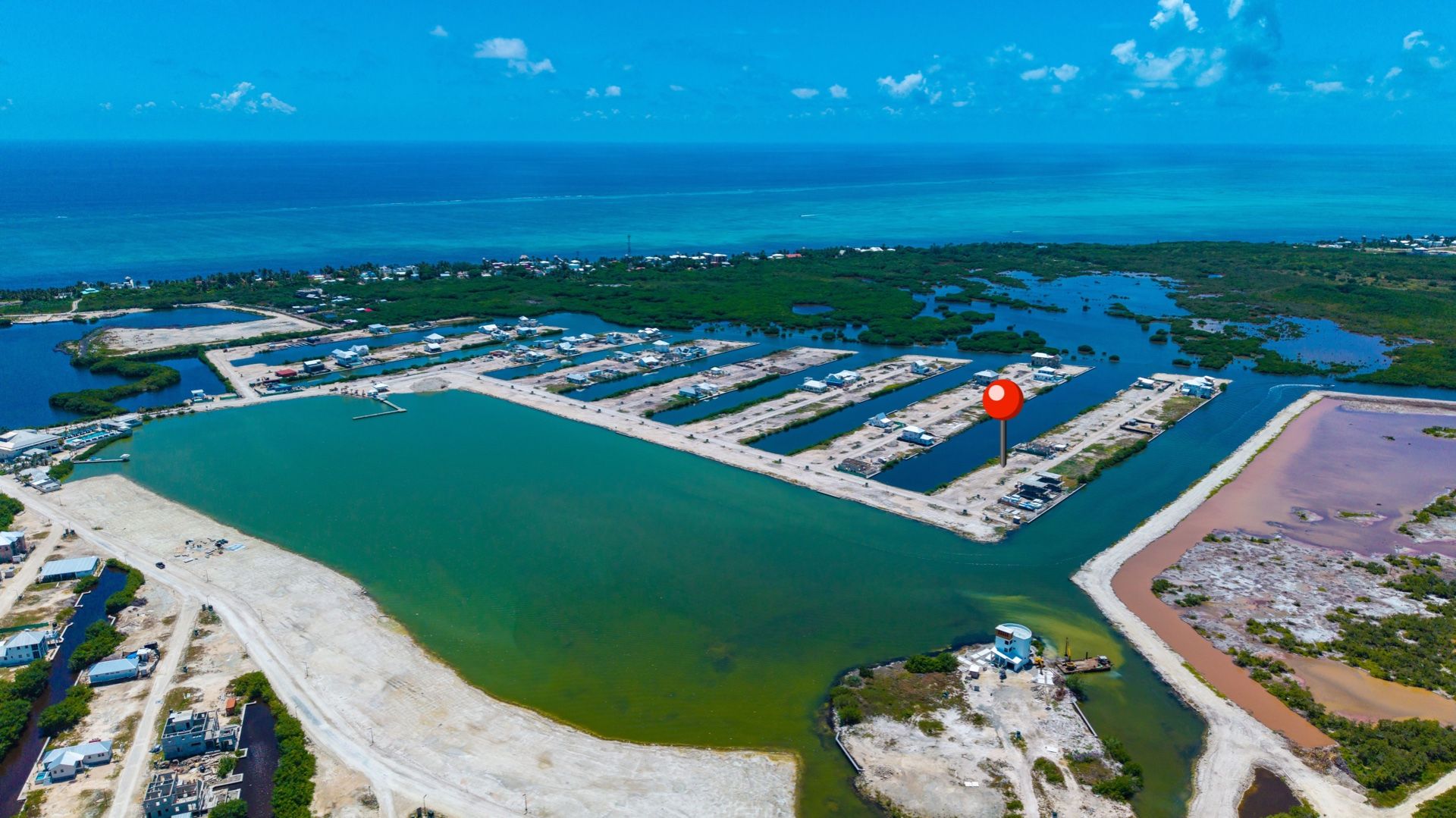 Aerial view of cleared waterfront lots beside canals and open sea