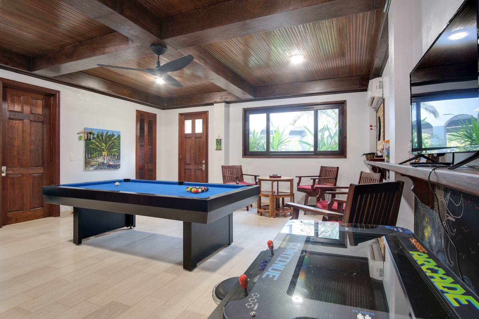 Game room with blue pool table, wood-beamed ceiling and air hockey table