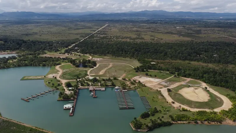 Aerial view of lakeside land with docks, boat slips and cleared open ground