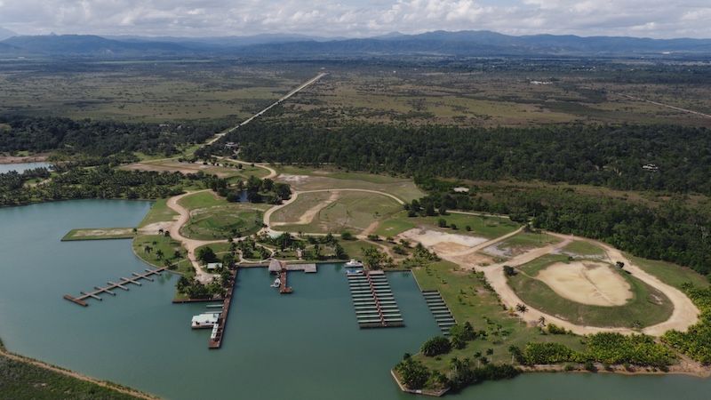Aerial view of a lakeside marina with docks, boat slips and cleared land